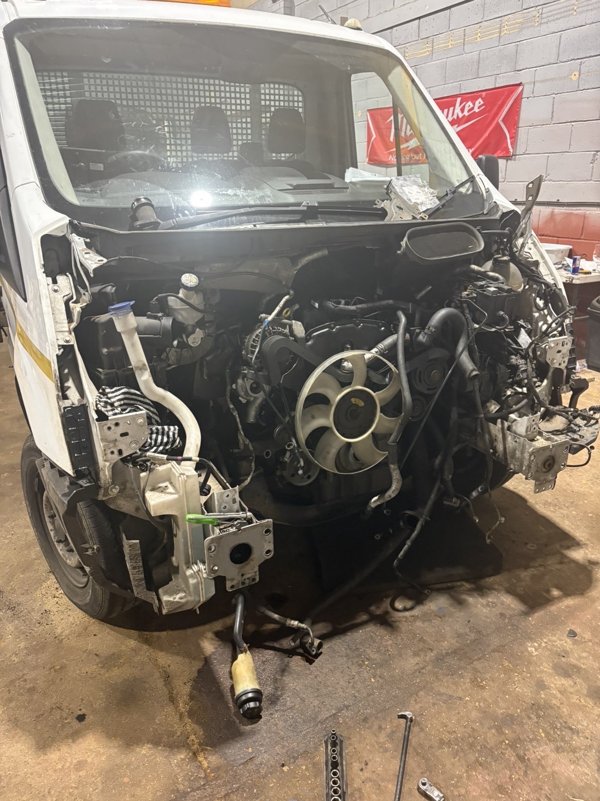 Transit van in the workshop with front end stripped down to the engine